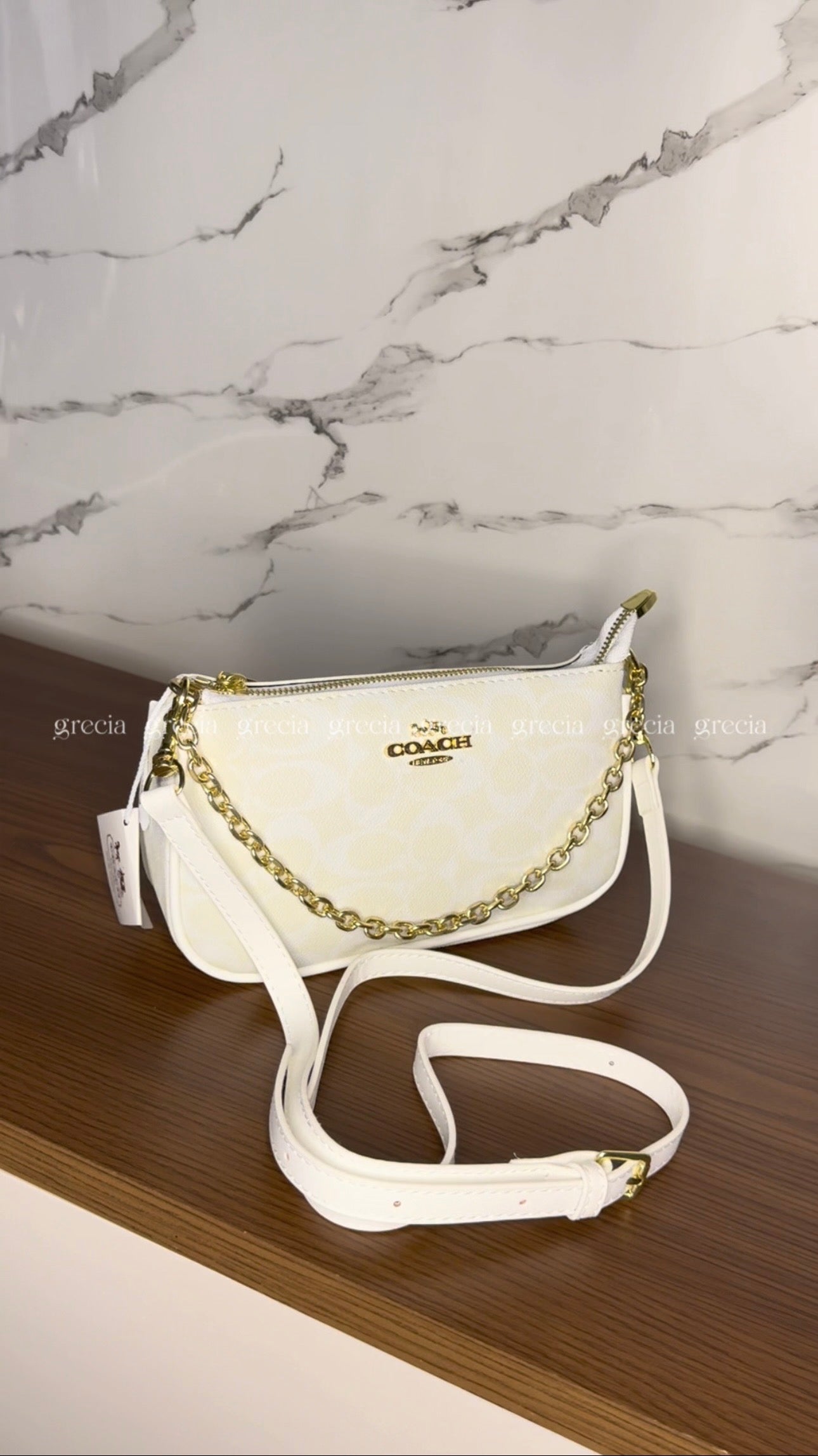 Coach Notita blanca